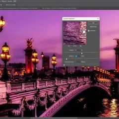 Immagine di Parigi con luci e ponte, con una finestra di dialogo "Unscharf maskieren" aperta per regolare la maschera di contrasto photoshop.