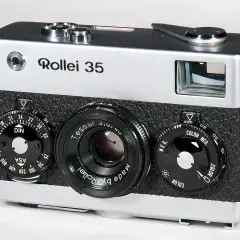 A silver and black Rollei 35 camera with a Tessar lens and multiple dials.