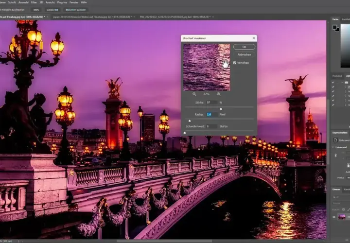 Immagine di Parigi con luci e ponte, con una finestra di dialogo "Unscharf maskieren" aperta per regolare la maschera di contrasto photoshop.