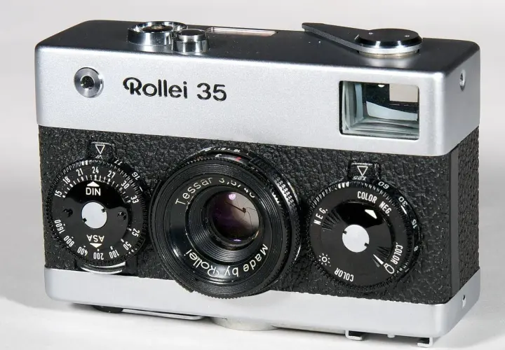 A silver and black Rollei 35 camera with a Tessar lens and multiple dials.