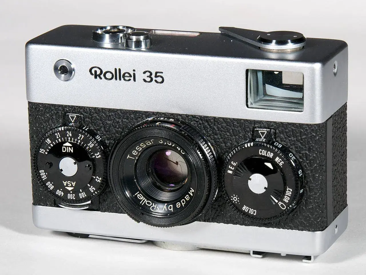 A silver and black Rollei 35 camera with a Tessar lens and multiple dials.